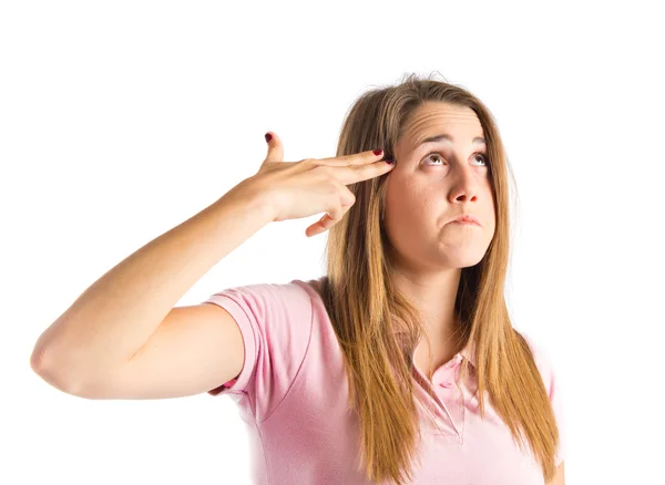 Young girl making suicide gesture over white background — Stock Photo, Image
