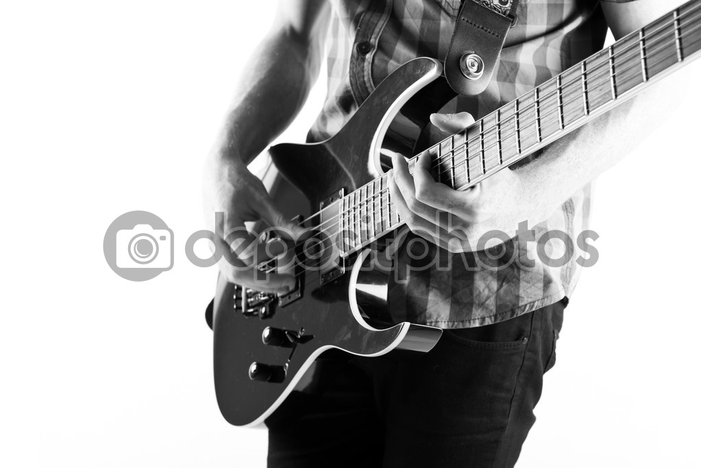 Young man playing guitar over white background 