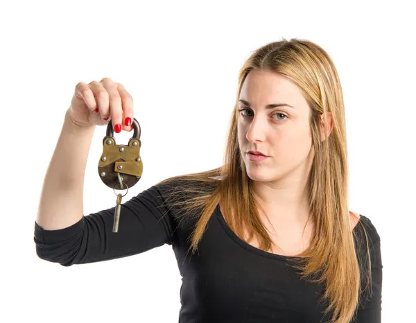 Blonde girl holding vintage padlock over white background — Stock Photo, Image