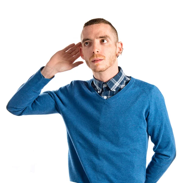 Hombre escuchando algo sobre fondo blanco —  Fotos de Stock