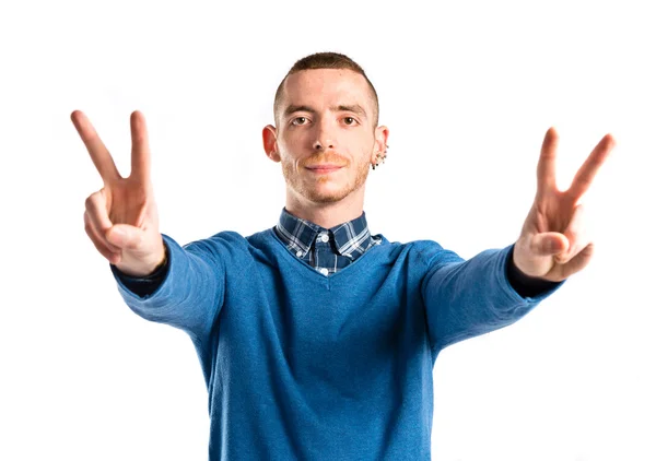 Man making victory gesture over isolated white background — Stock Photo, Image