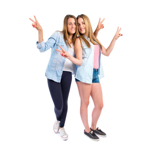 Friends doing victory gesture over white background — Stock Photo, Image