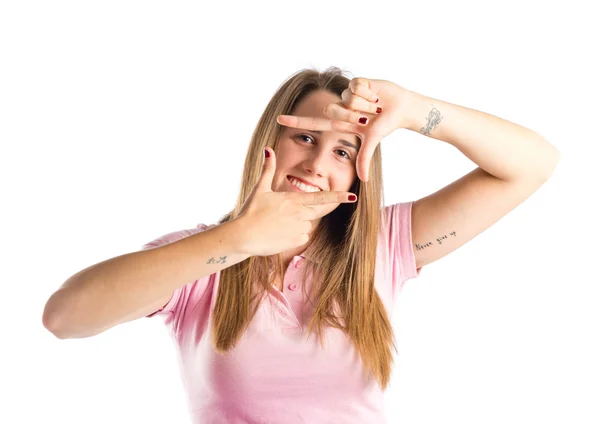 Young girl focusing with her fingers on a white background — Stock Photo, Image