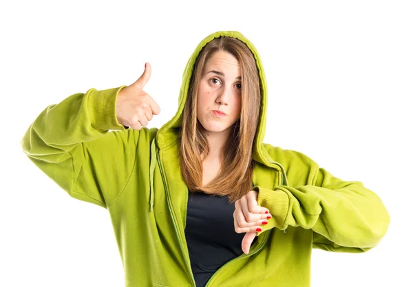 Young redhead making a good-bad sign over white background — Stock Photo, Image