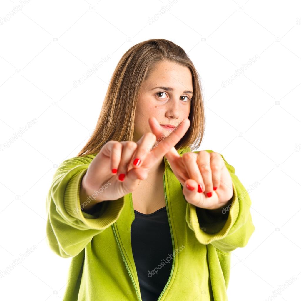 Girl doing NO gesture over white background 