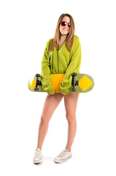 Skater with green sweatshirt over white background — Stock Photo, Image