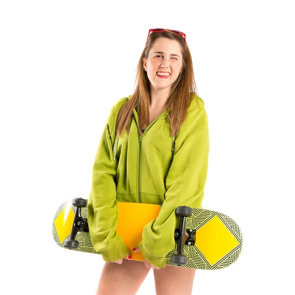 Blonde girl with skate over white background — Stock Photo, Image