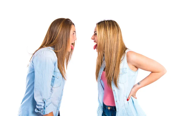 Girls doing a joke over isolated white background — Stock Photo, Image