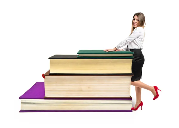 Affärskvinna med böcker över vit bakgrund — Stockfoto