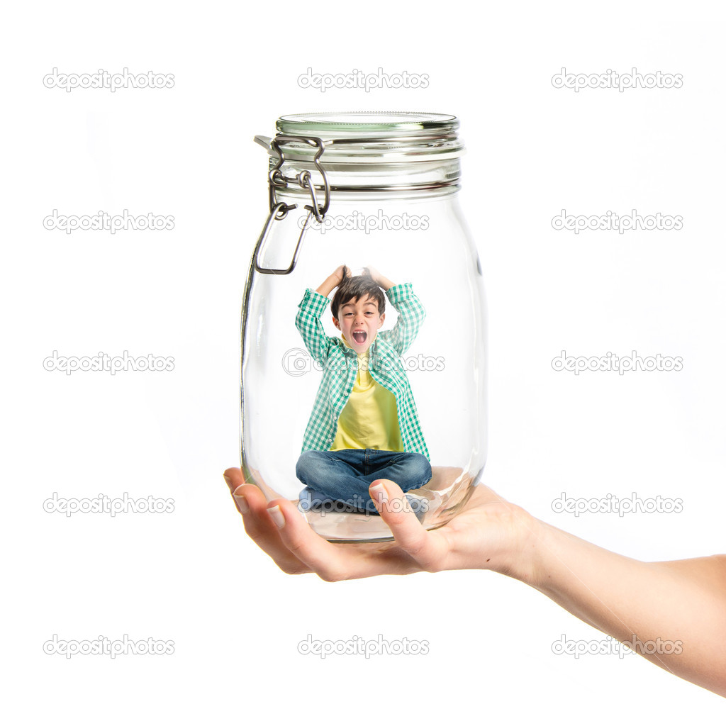 Enclosed kid inside jar glass over white background 