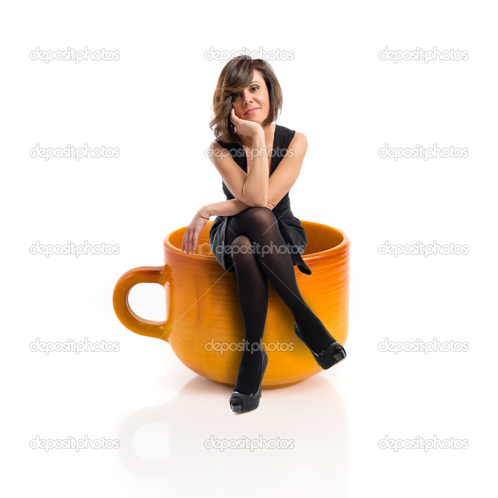 Woman sitting on a ceramic cup over white background