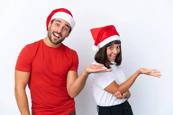 Junges Paar Mit Weihnachtsmütze Auf Weißem Hintergrund Die Hände Zur — Stockfoto