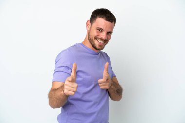 Beyaz arka planda izole edilmiş genç Brezilyalı adam öne bakıyor ve gülümsüyor.