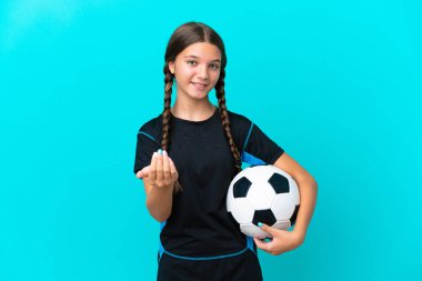 Mavi arka planda, futbol topuyla izole edilmiş küçük beyaz kız geliyor.
