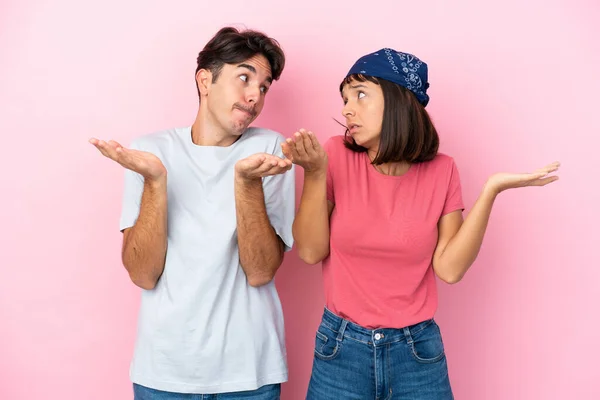 Young Couple Isolated Pink Background Making Unimportant Gesture While Lifting — Stock Photo, Image