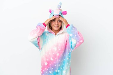 Beyaz arka planda tek boynuzlu at pijamalı küçük bir kız. Şaşırtıcı bir ifadeyle.