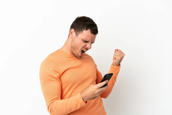 Hombre Brasileño Sobre Fondo Blanco Aislado Con Teléfono Posición Victoria —  Fotos de Stock