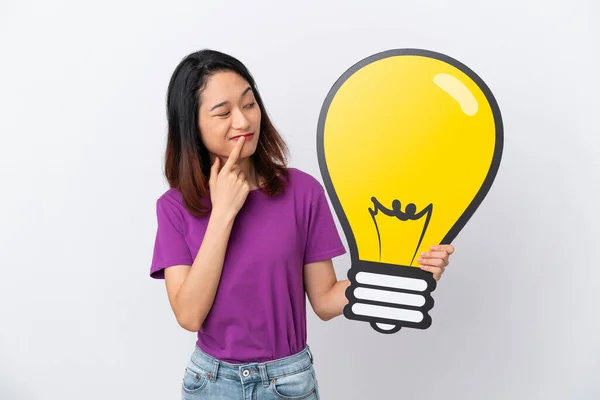 Young Vietnamese Woman Isolated White Background Holding Bulb Icon Having — Stock Photo, Image