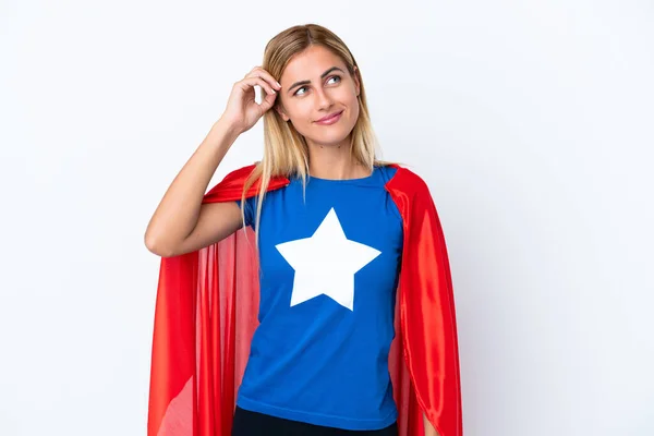 Super Hero caucasian woman isolated background having doubts and with confuse face expression