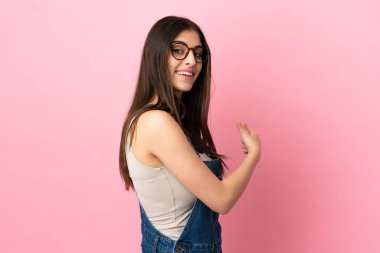 Pembe arka planda izole edilmiş beyaz bir kadın.