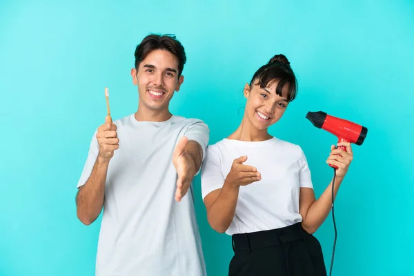 Jovem Casal Misto Segurando Secador Cabelo Escova Dentes Isolado Fundo — Fotografia de Stock