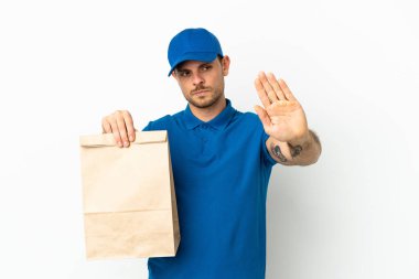 Brezilyalı, beyaz arka planda izole edilmiş bir paket yiyecek alıyor. Durma hareketi yapıyor ve hayal kırıklığına uğruyor.