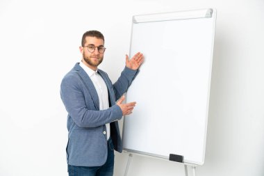 Beyaz arka planda beyaz tenli yakışıklı bir adam beyaz panoda sunum yapıyor.