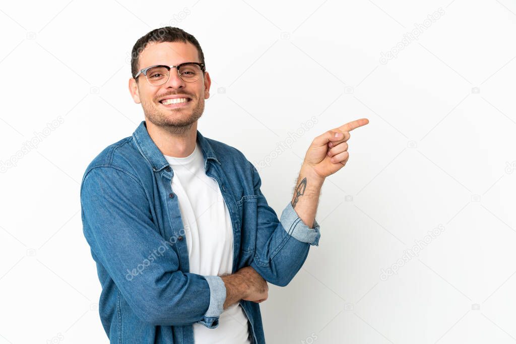 Brazilian man over isolated white background pointing finger to the side