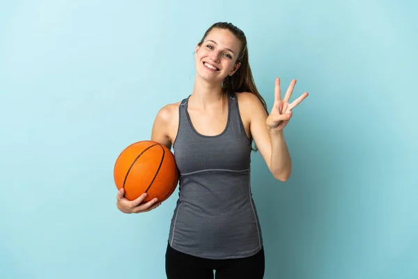 Młoda Kobieta Gra Koszykówkę Odizolowany Niebieskim Tle Szczęśliwy Liczyć Trzy — Zdjęcie stockowe