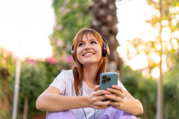 Joven Mujer Pelirroja Bonita Aire Libre Escuchando Música Con Móvil —  Fotos de Stock