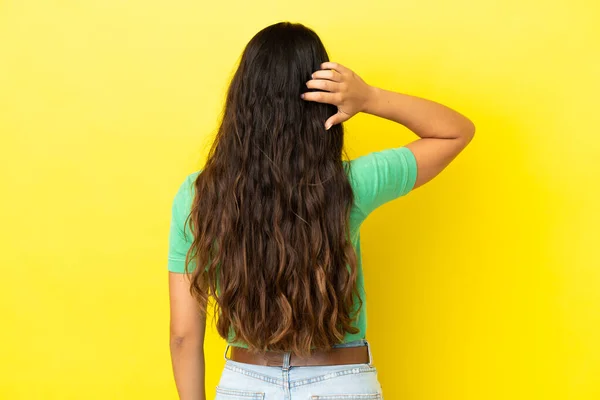 Young Caucasian Woman Isolated Yellow Background Back Position Thinking — Stock Photo, Image