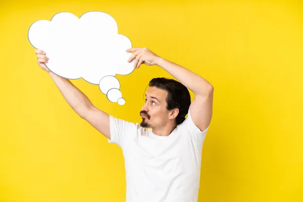 Young Caucasian Man Isolated Yellow Background Holding Thinking Speech Bubble — Stock Photo, Image