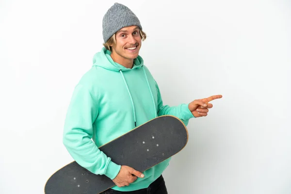 Young Skater Blonde Man Isolated White Background Pointing Finger Side — Stock Photo, Image