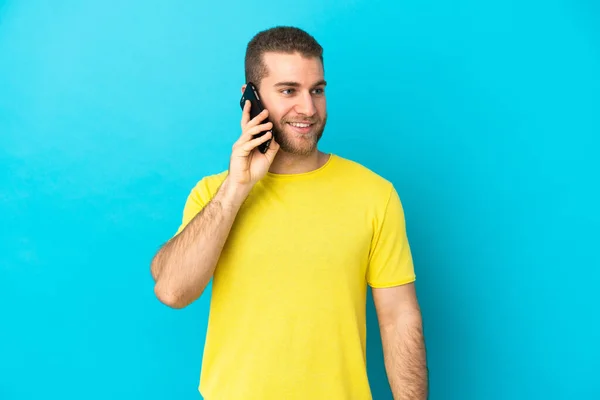 Young Handsome Caucasian Man Isolated Blue Background Keeping Conversation Mobile — Stock Photo, Image