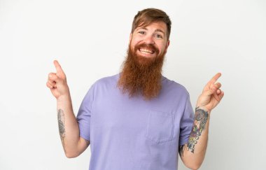 Beyaz arka planda izole edilmiş genç, kırmızı beyaz bir adam parmak uçlarını işaret ediyor ve mutlu