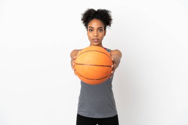 Genç basketbolcu Latin kadın, beyaz arka planda izole edilmiş basketbol oynuyor.