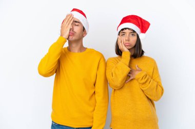 Genç melez çift Noel 'i beyaz arka planda yalnız kutluyor. Şaşırmış ve şok olmuş bir yüz ifadesi var.