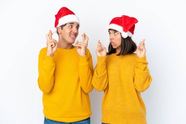 Genç melez çift, beyaz arka planda izole edilmiş bir şekilde Noel 'i kutlarken şans diliyor.