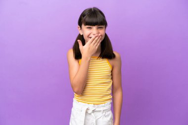 Mor arka planda izole edilmiş küçük beyaz çocuk mutlu ve gülümsüyor.