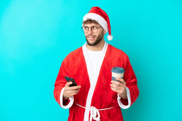 Young Man Disguised Santa Claus Isolated Blue Background Holding Coffee — Stock Photo, Image