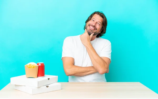 Senior Dutch Man Eating Fast Food Sitting Table Happy Smiling — Stock Photo, Image