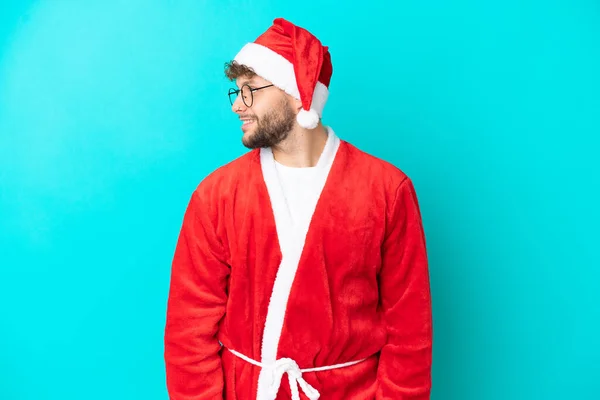 Young Man Disguised Santa Claus Isolated Blue Background Looking Side — Stock Photo, Image