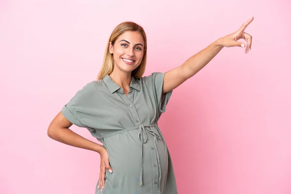 Mladá Uruguayská Žena Izolované Modrém Pozadí Těhotná Ukazuje Laterální — Stock fotografie