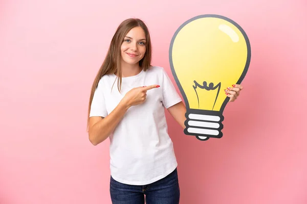 Young Lithuanian Woman Isolated Pink Background Holding Bulb Icon Pointing — Stock Photo, Image