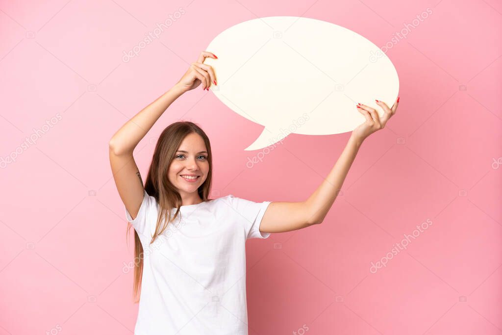 Young Lithuanian woman isolated on pink background holding an empty speech bubble