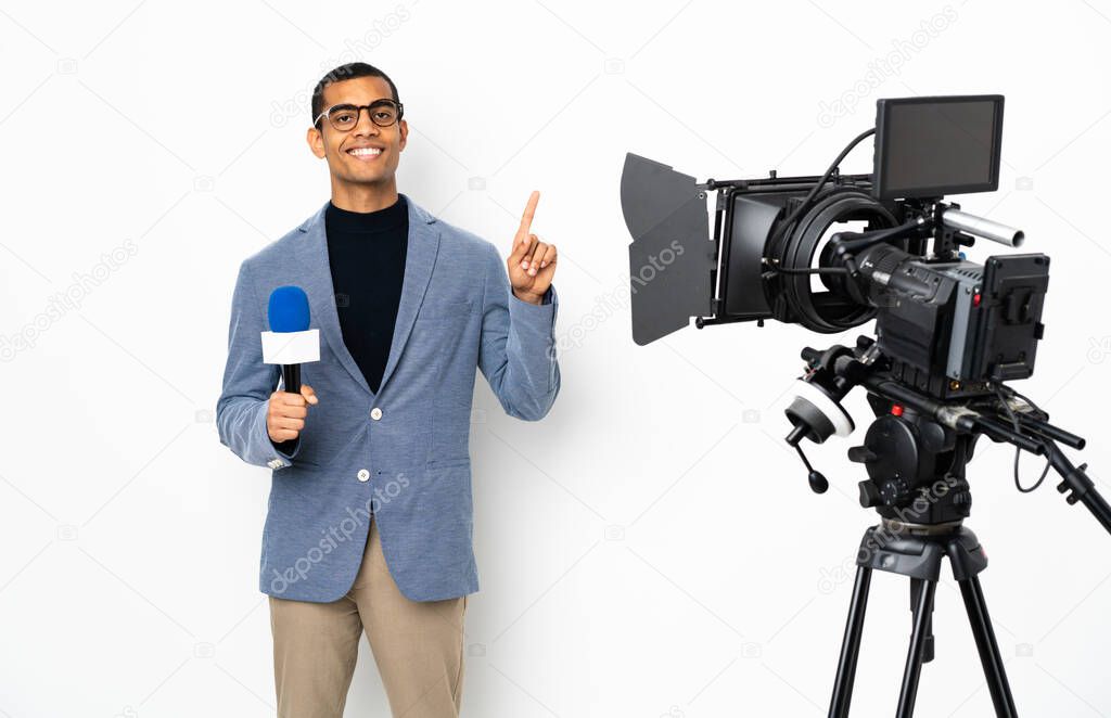 Reporter African American man holding a microphone and reporting news over isolated white background showing and lifting a finger in sign of the best