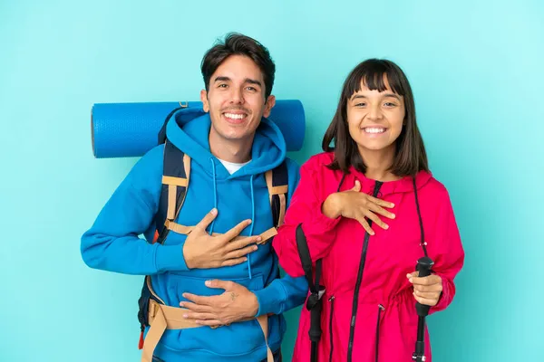 Jóvenes Montañeros Pareja Aislada Sobre Fondo Azul Sonriendo Mucho Mientras —  Fotos de Stock
