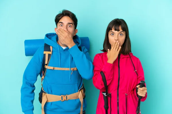 Jóvenes Montañistas Pareja Aislada Sobre Fondo Azul Cubriendo Boca Con — Foto de Stock