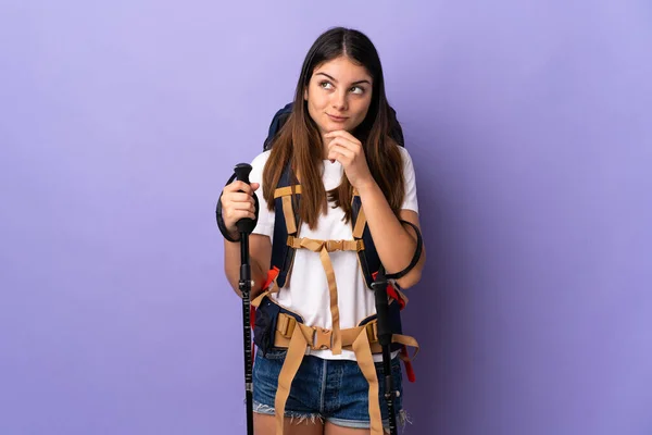Young Woman Backpack Trekking Poles Isolated Purple Background Looking — Stock Photo, Image