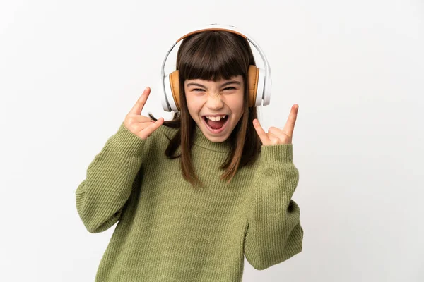 小さな女の子リスニング音楽とともにモバイル孤立した上にホワイトバックグランドリスニング音楽作る岩ジェスチャー — ストック写真